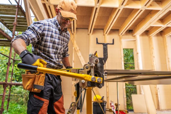 Sheet Metal Folding Machine Operating by Caucasian Construction Worker in His 40s